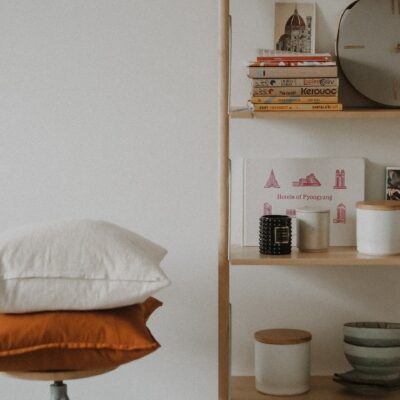 Pillows on stool with stylish storage shelves